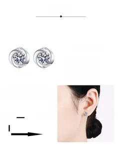 Macro shot of S925 sterling silver swirl earrings with moissanite stones and rhodium plating