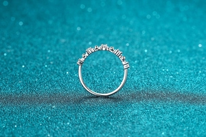 Macro detail of silver S925 ring featuring I Love You hollow letters set with pavé zircons