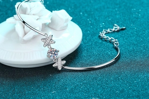 Macro detail of S925 silver bracelet featuring a 1ct moissanite and star accents