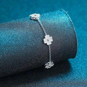Polished 925 sterling silver chain bracelet with shimmering pavé set flower charms