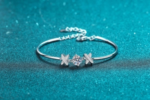 Detail of S925 silver bracelet featuring one carat round stone and X-shape cross design
