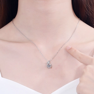 Elegant S925 silver necklace featuring a sparkling round moissanite pendant on a model