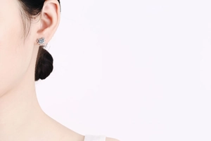 Close-up of S925 sterling silver reindeer horn earring with a round moissanite stone