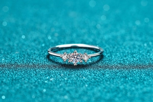 Macro shot of S925 sterling silver ring with three-stone moissanite setting in high detail