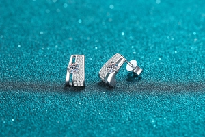 Macro shot of S925 silver earrings with prong-set moissanite and micro-pave crystals