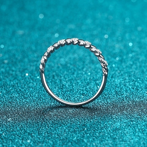 S925 sterling silver twist ring featuring a half-circle of pavé set moissanite stones