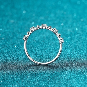 Elegant 925 sterling silver ring with crystal-encrusted letters on shimmering blue background