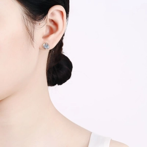 Elegant S925 sterling silver cyclone earrings with moissanite stones on model's ear