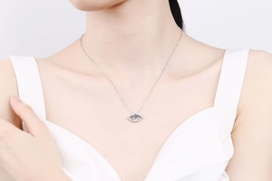 Close-up of 925 silver Evil Eye necklace with blue moissanite on model's neck