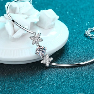 Elegant S925 sterling silver bangle featuring a moissanite solitaire and cross star accents