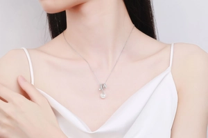 Close-up of S925 silver necklace with an 8mm freshwater pearl and moissanite star detail
