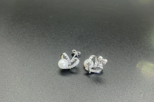 Détails macro des boucles d'oreilles cœur en argent S925 avec perles et zircons