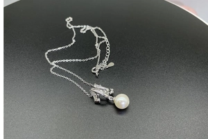 Close-up of S925 silver cross chain with M-letter pendant and 8mm freshwater pearl