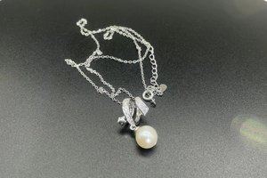 Close-up of S925 sterling silver necklace with 8mm freshwater pearl and moissanite detail