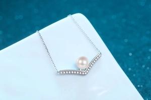 Macro view of 8mm freshwater pearl pendant on a S925 silver V-shaped necklace