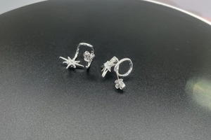 Detailed close-up of 925 sterling silver snowflake earrings with moissanite inlays