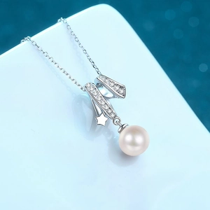 S925 sterling silver necklace with freshwater pearl and star pendant on blue bokeh background