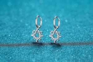 Detail of S925 sterling silver hoop earrings with shimmering geometric star-shaped charms