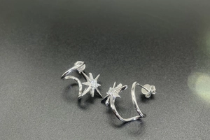 Detailed macro view of 925 silver snowflake earrings with micro-inlaid zircon stones