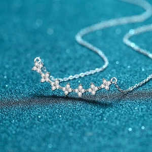 Elegant S925 sterling silver necklace featuring seven clover charms with sparkling stones