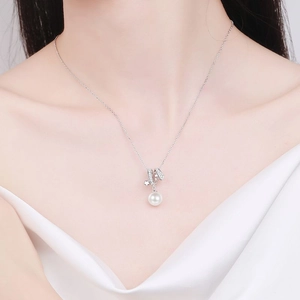 S925 sterling silver necklace with freshwater pearl and star pendant on a female model