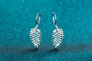 Detail of S925 sterling silver leaf earrings with sparkling moissanite accents