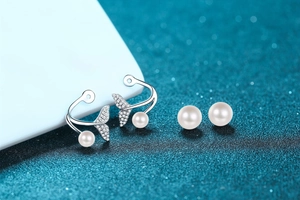 Macro view of S925 silver mermaid tail earrings featuring white pearls and stones