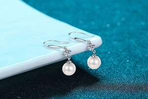 Detail view of 925 sterling silver earring featuring 8mm freshwater pearl and moissanite stone