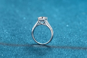 Macro shot of S925 sterling silver ring with emerald cut moissanite and pave diamonds