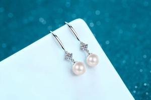 Detail of S925 silver earrings featuring 8mm freshwater pearls and Moissanite accents