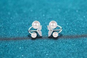 Macro detail of S925 silver mermaid tail earrings with freshwater pearls and diamonds