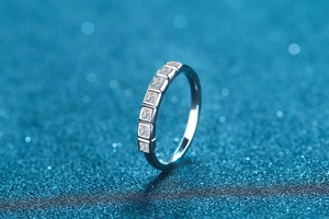 Close-up of S925 sterling silver ring with seven princess cut moissanite stones