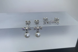 Detailed shot of S925 sterling silver bow earrings with round white freshwater pearls