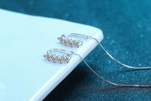 Close-up of S925 sterling silver drop earrings with sparkling moissanite stones and box chains