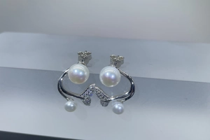 Close-up of S925 sterling silver mermaid tail earrings with freshwater pearls and zircons
