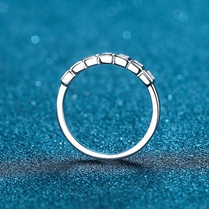 Elegant S925 sterling silver ring with princess cut moissanite stones on blue background