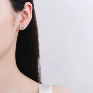 Elegante S925 Silber Moissanit Ohrstecker im Prinzess-Schliff am Ohr des Models