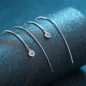 Elegant S925 sterling silver tassel drop earrings with round moissanite on dark stand