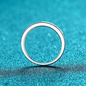 Minimalist 925 sterling silver band ring with moissanite pavé stones on blue background