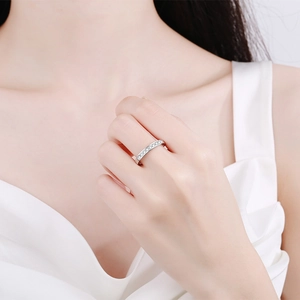 Minimalist 925 sterling silver band ring featuring a row of shimmering round moissanite