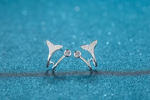 Macro detail of mermaid tail earrings in S925 sterling silver with sparkling pavé stones