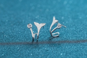 Macro detail of S925 sterling silver mermaid tail earrings with sparkling pavé stones