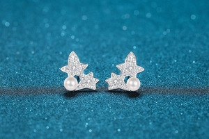 Detail of S925 sterling silver earrings with freshwater pearl and moissanite stars