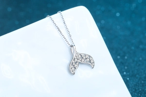 Detailed view of S925 sterling silver mermaid tail pendant necklace with pavé moissanite