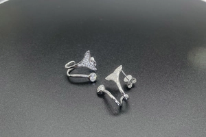 Close-up of S925 silver mermaid tail earrings with shimmering pavé micro-inlaid stones