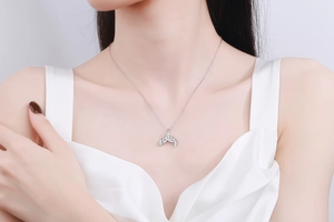 Close-up of S925 silver mermaid tail pendant necklace with pavé moissanite stones