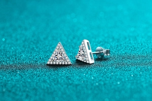 Macro shot of S925 sterling silver triangle stud earring with sparkling central gemstone