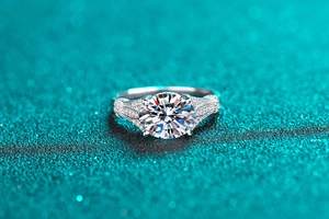 Macro shot of 3 carat round cut moissanite ring with luxury micro-pave sterling silver band