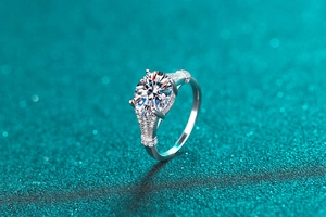 Macro shot of 3 carat moissanite ring with pave diamonds on blue sparkling background
