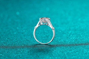 Close-up of a 3-carat Moissanite ring with S925 silver four-prong setting and side diamonds
